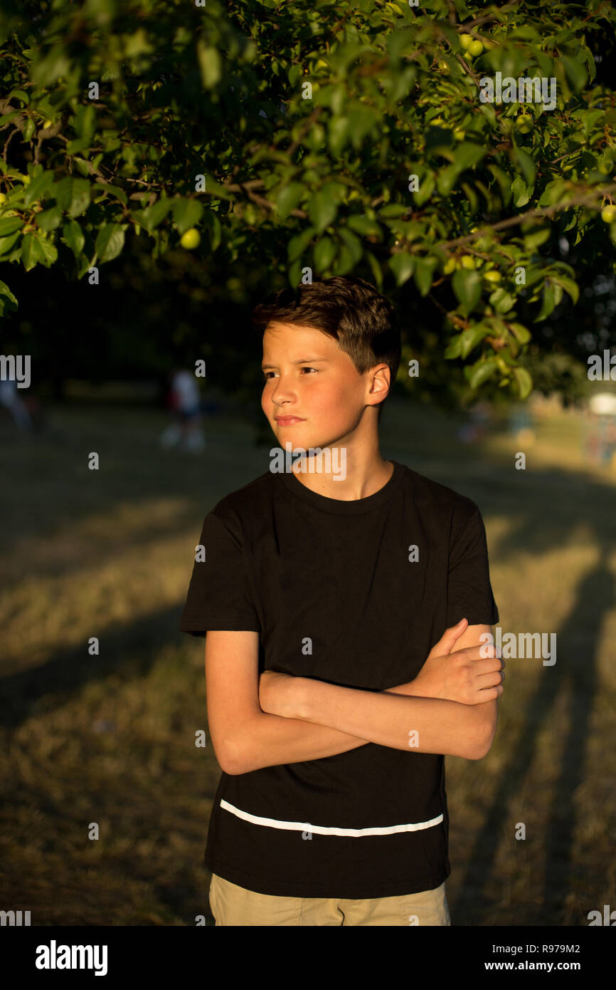 Portrait of young smiling teen boy in garden Stock Photo