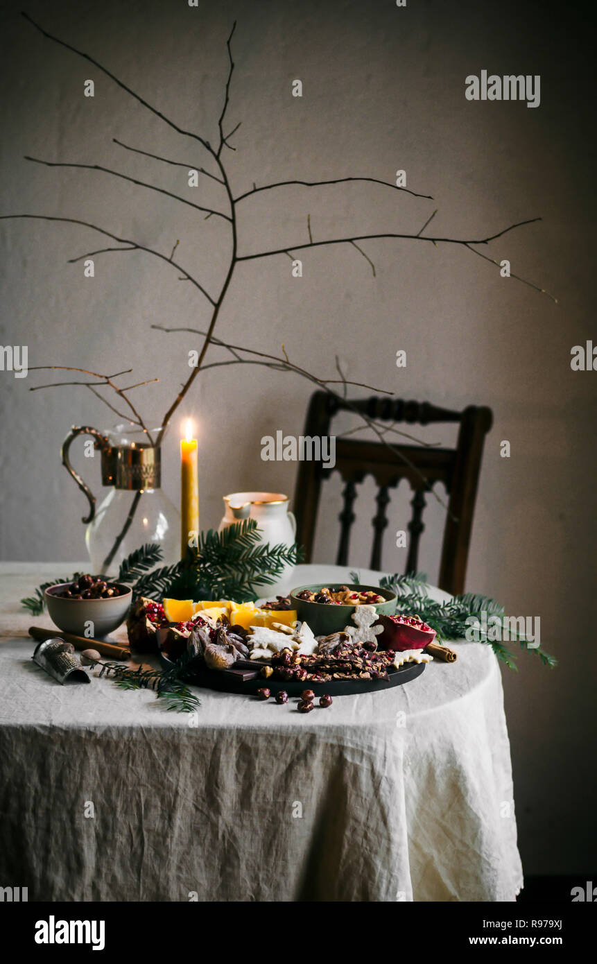 Holiday tablescape with chocolate bark, dried fruit, fruit, and dip Stock Photo