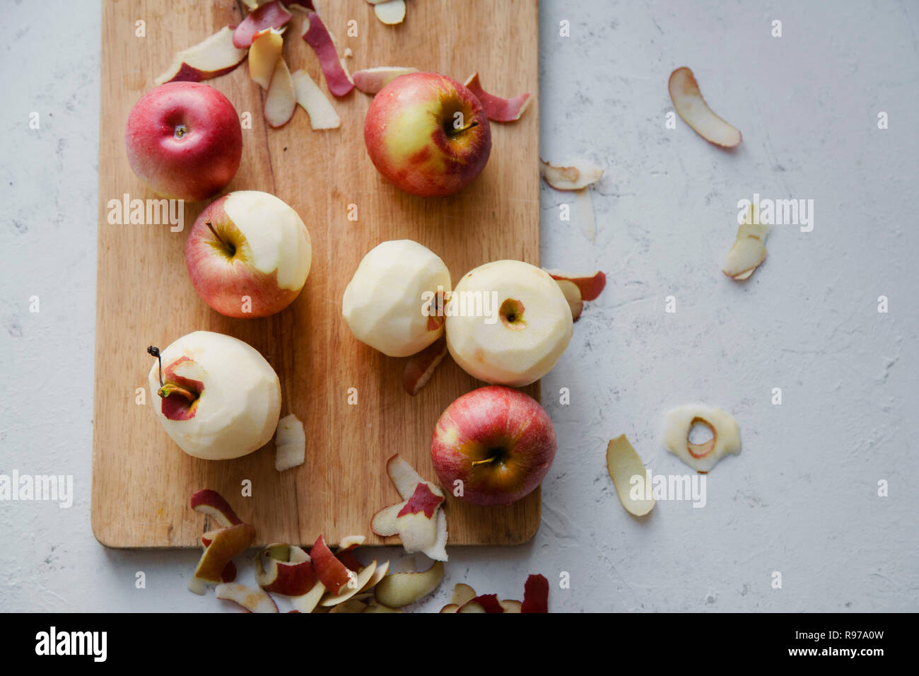 Peeling red apples for cooking an apple pie Stock Photo