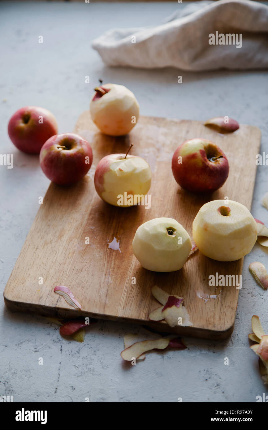 Peeling red apples for cooking an apple pie Stock Photo