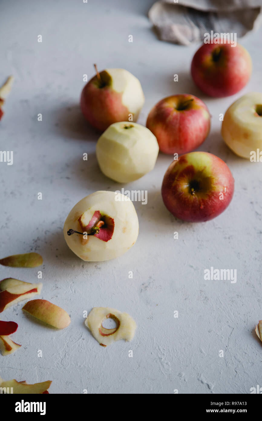 Peeling red apples for cooking an apple pie Stock Photo