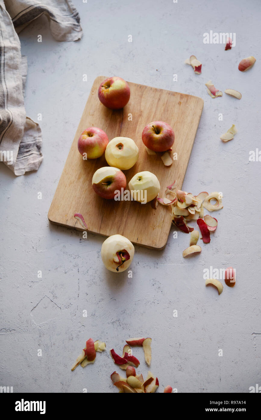 Peeling red apples for cooking an apple pie Stock Photo