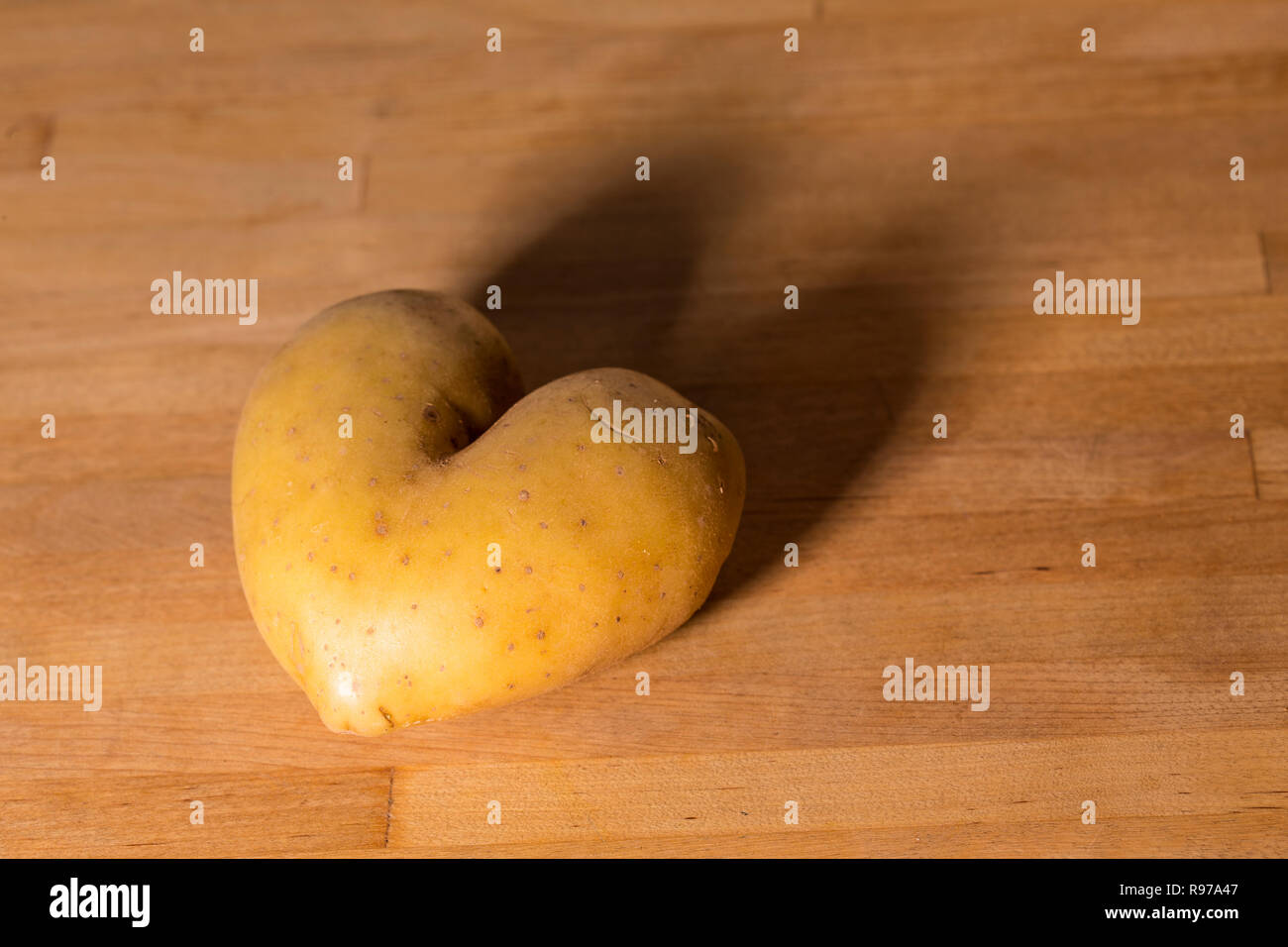 Potato in heart shape Stock Photo