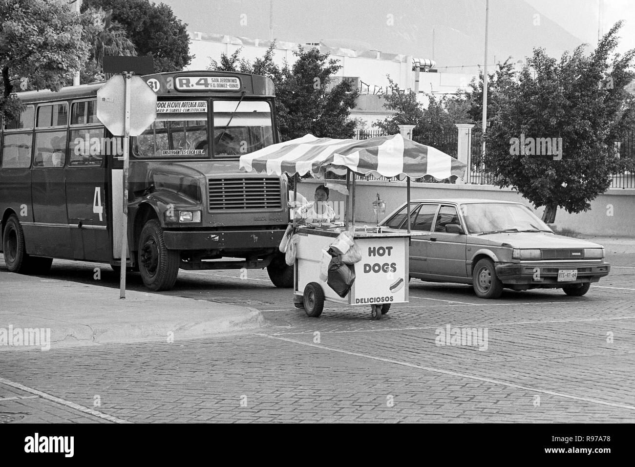 MONTERREY, NL/MEXICO - NOV 2, 2003: A hot dog peddler driving her cart on the street Stock Photo