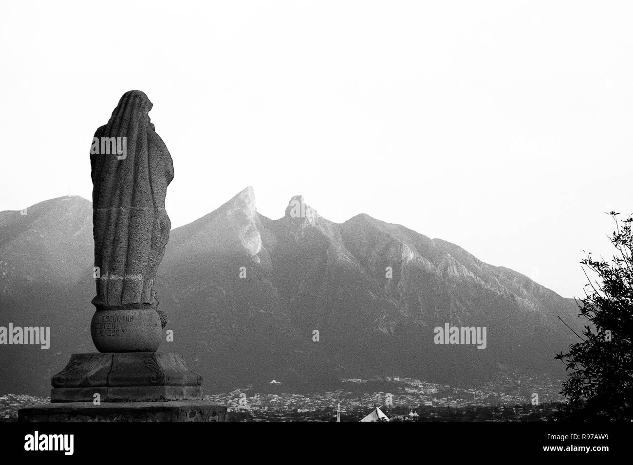 MONTERREY, NL/MEXICO - NOV 20, 2002: View from the Bishop's museum, Virgin of the Immaculate Conception sculpture and La Silla hill at dusk Stock Photo