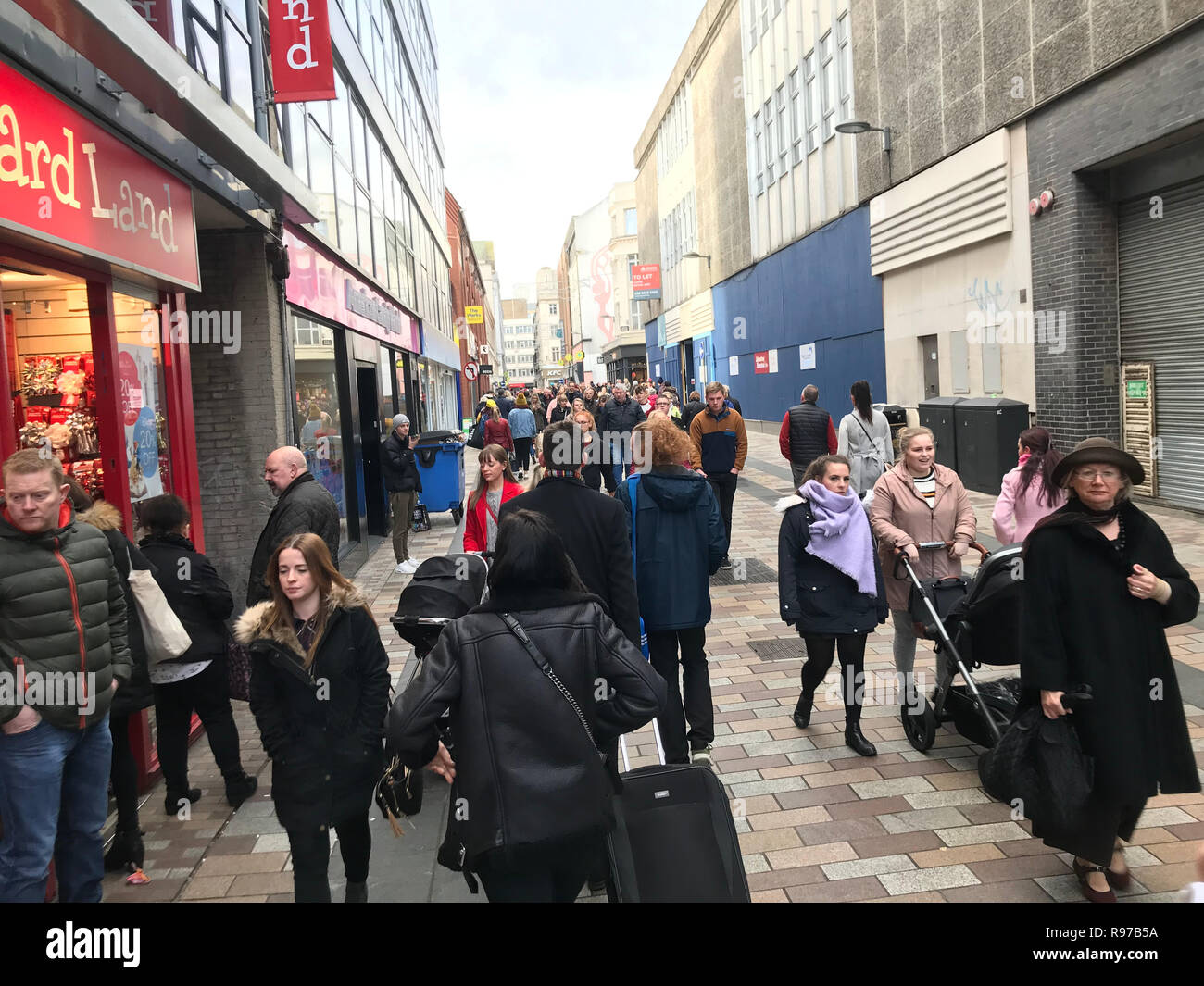 Shoppers in Belfast city centre where despite the restrictions still in place due to August's Primark fire the city centre has been busier this Christmas shopping season. Stock Photo