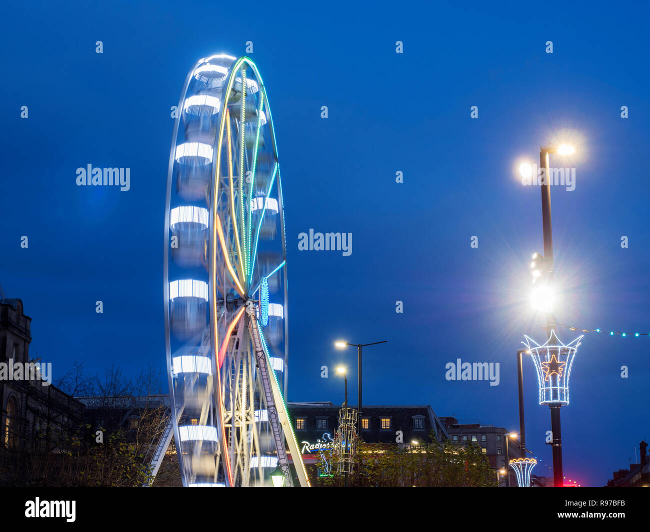 Leeds Wheel of Light illuminated at dusk at Christmas on The Headrow in