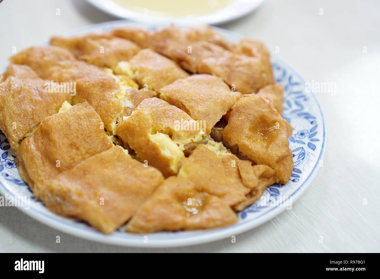 The deep fried bread cook with omelette served with condensed milk