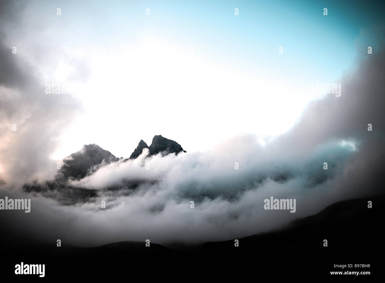 Fog and clouds with mountain peak Stock Photo - Alamy