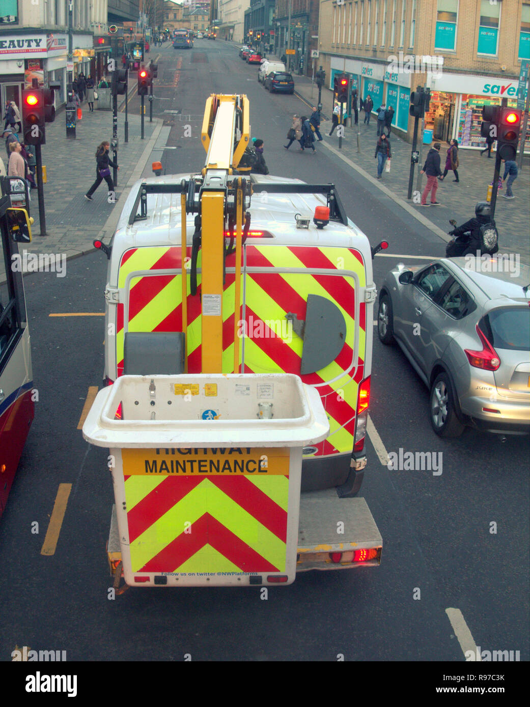 highway maintenance van on road with platform stuck in traffic at red light Stock Photo