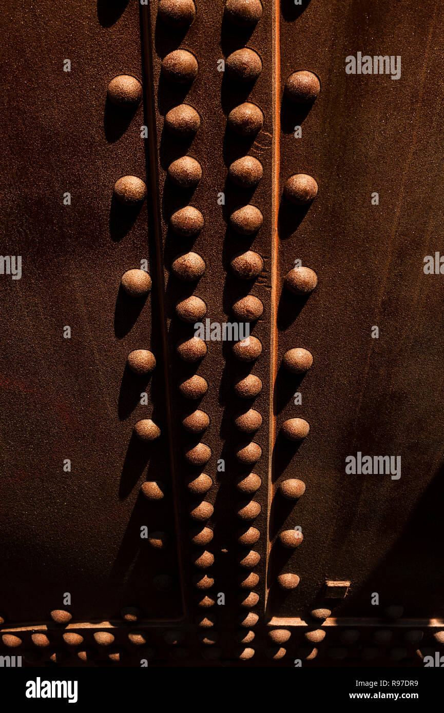 Rivets close-up along metal storage tank creating a design element Stock Photo