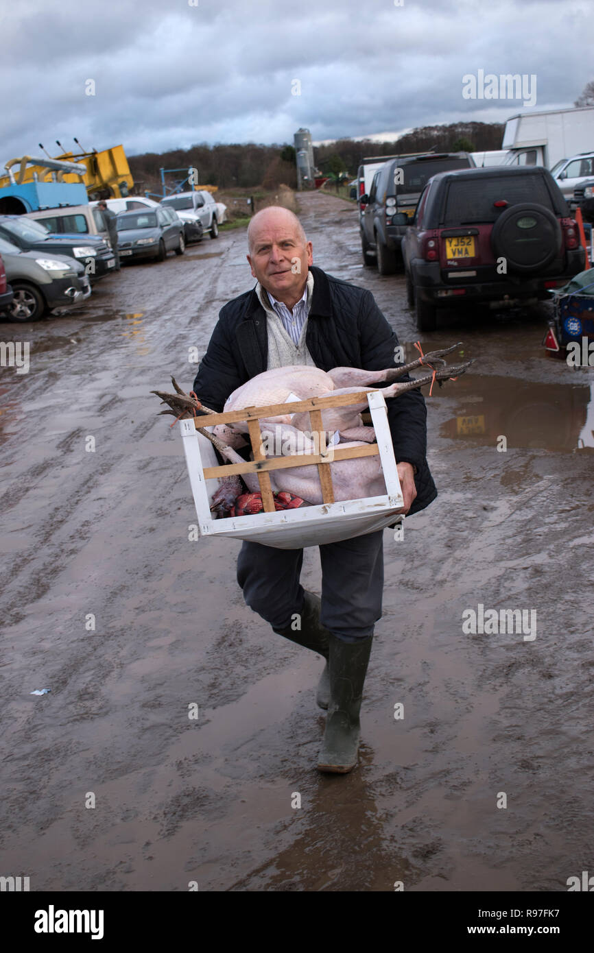 Christmas turkey auction Norfolk, man with two turkeys he has just bought 2010s England UK HOMER SYKES Stock Photo