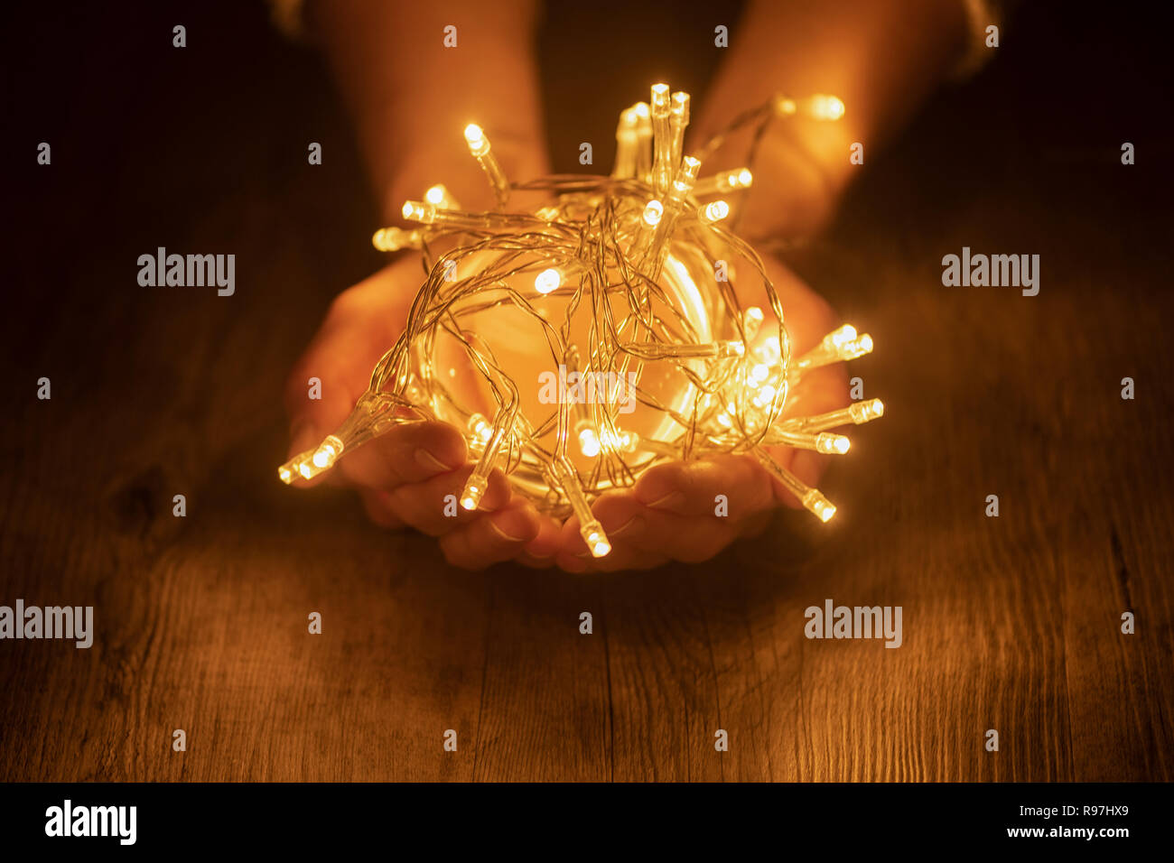 Hands holding a ball of fairy lights Stock Photo