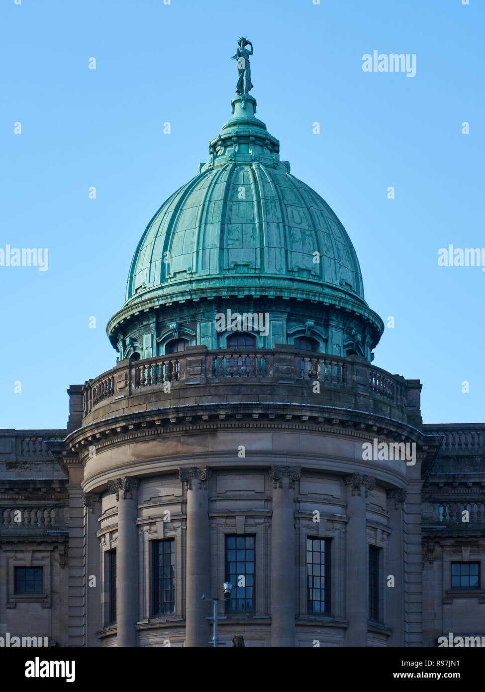Domed green copper roof of a Mitchell Library building positioned next to an M8 motorway in Glasgow. Stock Photo