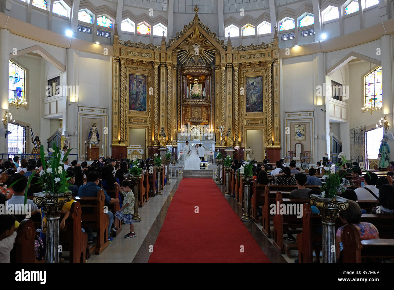 Wedding ceremony inside the Roman Catholic Antipolo Cathedral or National Shrine of Our Lady of Peace and Good Voyage located in the city of Antipolo, in the province of Rizal in the Philippines. Stock Photo