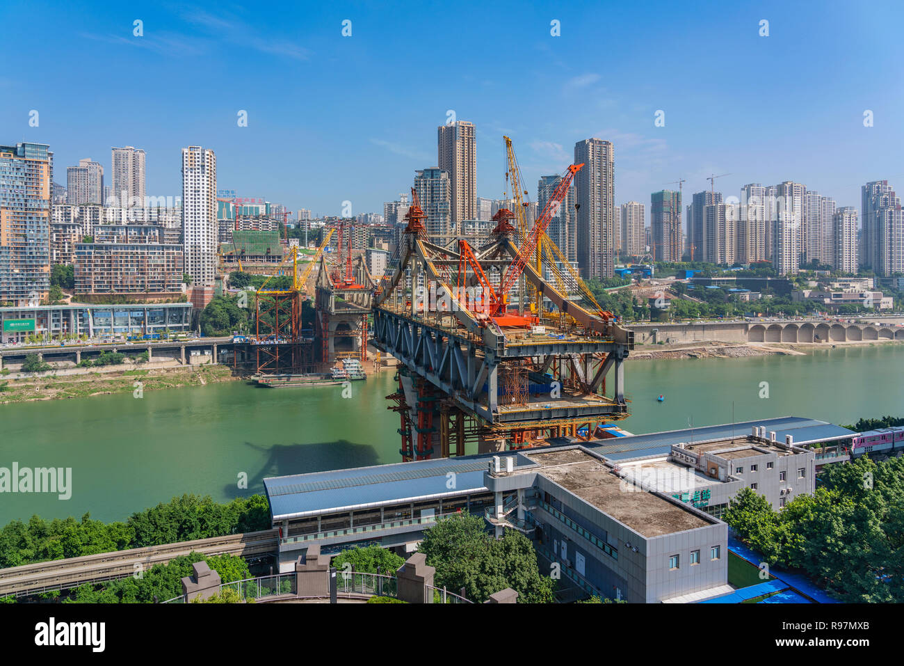 CHONGQING, CHINA - SEPTEMBER 19: View of riverside city buildings and a new bridge under construction along the Yangtze river in Chongqing on Septembe Stock Photo