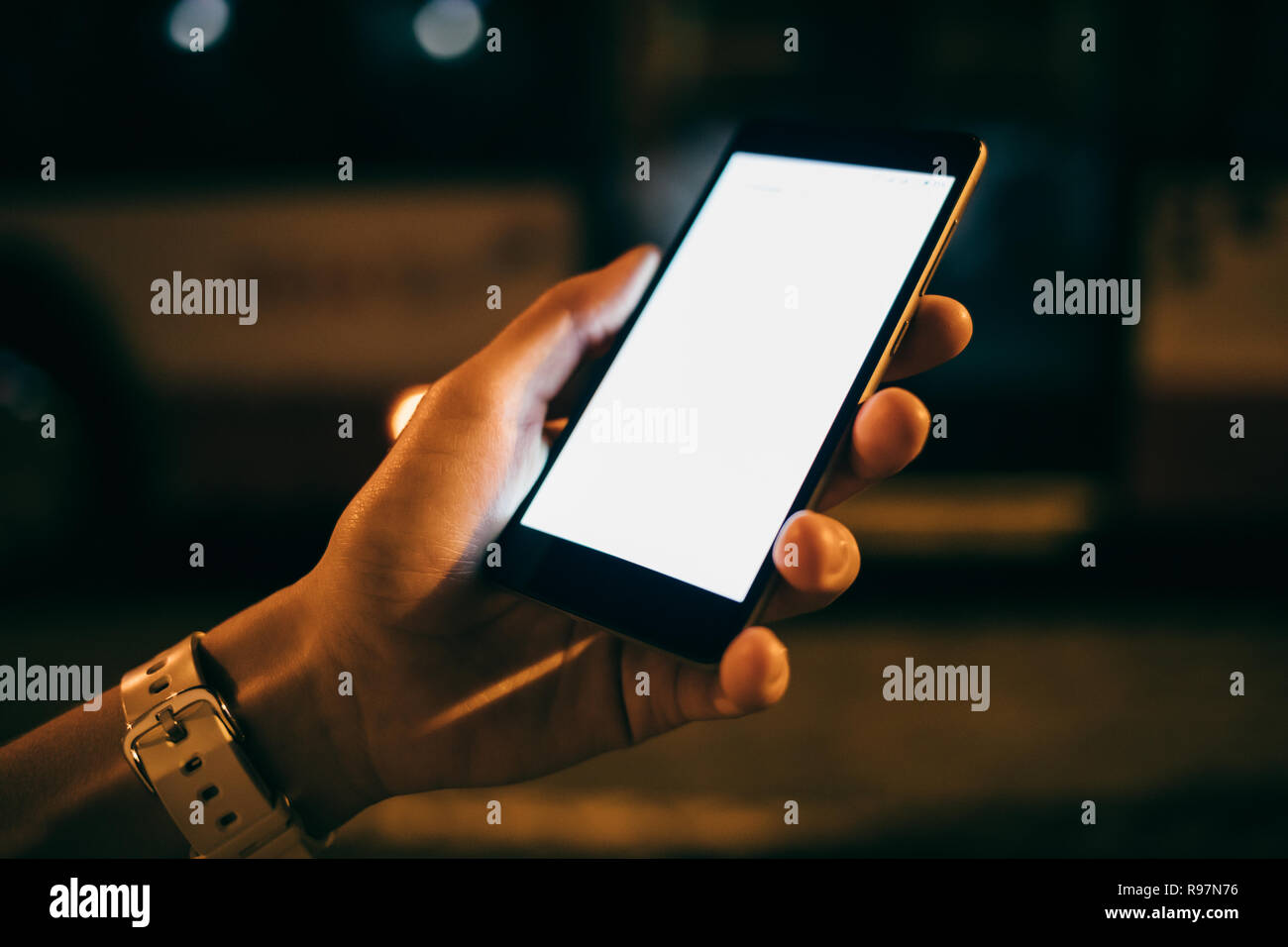 Close Up Woman S Hand Holding Mobile Phone With Blank Touch Screen In City At Night In Yellow Lights Stock Photo Alamy