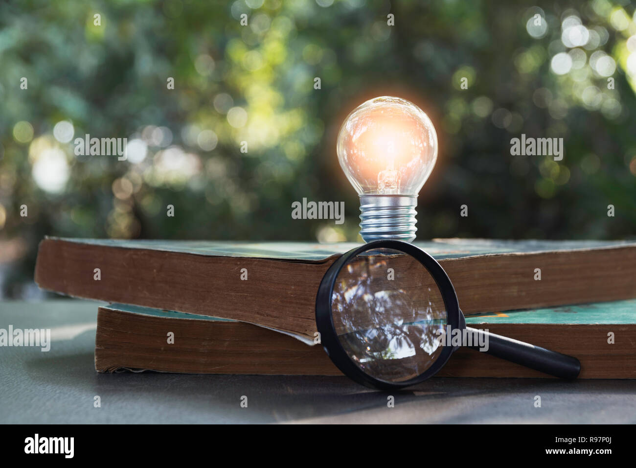 Light bulb and pile of book on table and copy space for insert text. Stock Photo