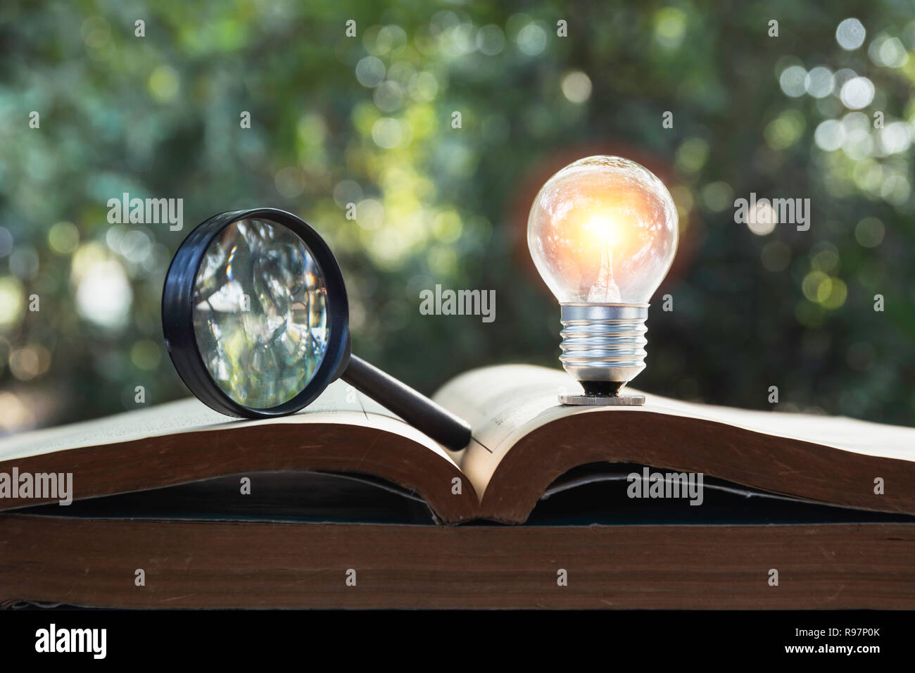 Light bulb and pile of book on table and copy space for insert text. Stock Photo