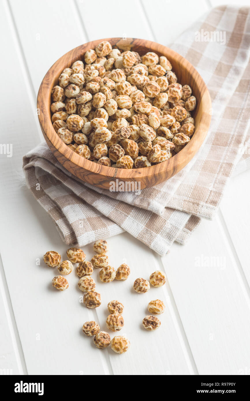 Tiger nuts. Tasty chufa nuts. Healthy superfood on white table. Stock Photo