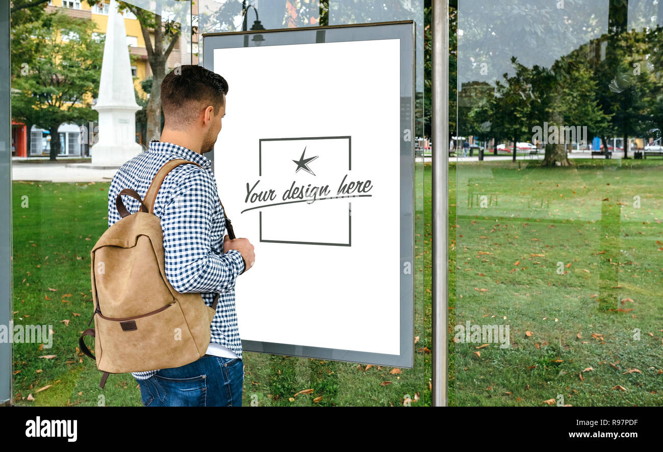Man from looking at bus marquee poster Stock Photo