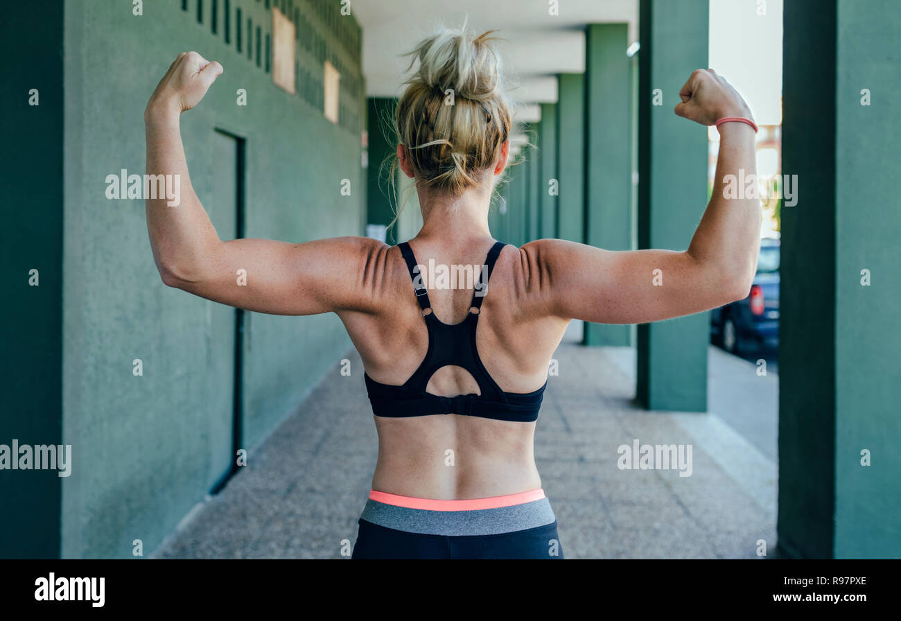 Sportswoman on her back showing muscles Stock Photo