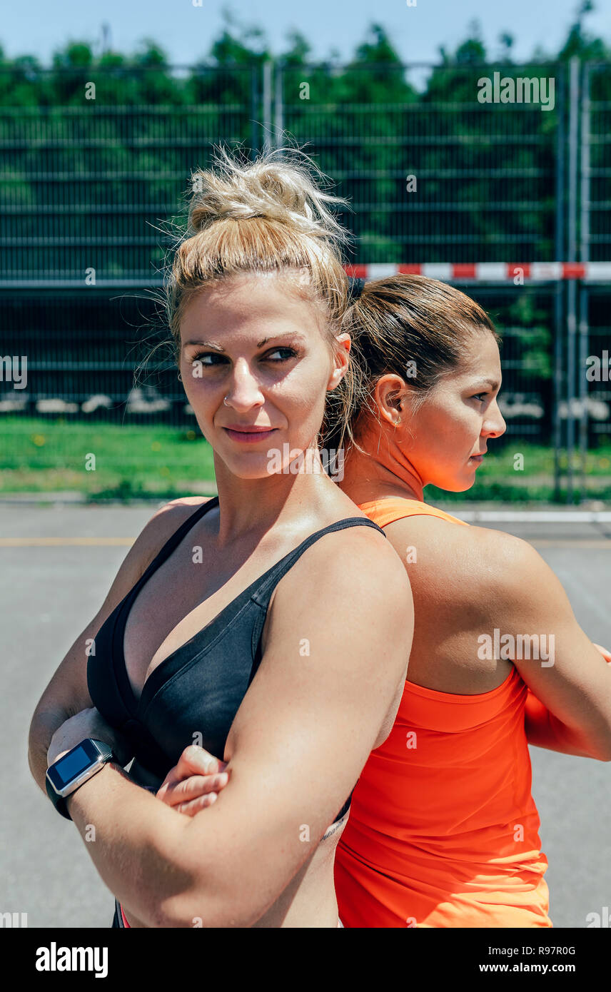 Sportswomen posing with crossed arms Stock Photo