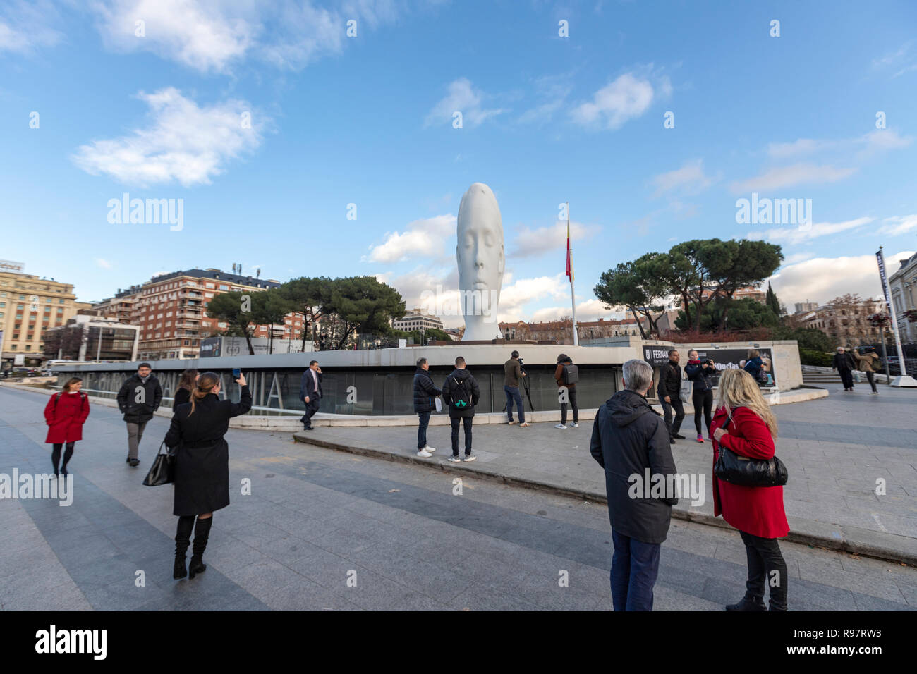 People taking pictures of Julia, white marble sculpture by Jaume Plensa in Plaza Colon, Madrid, Spain Stock Photo