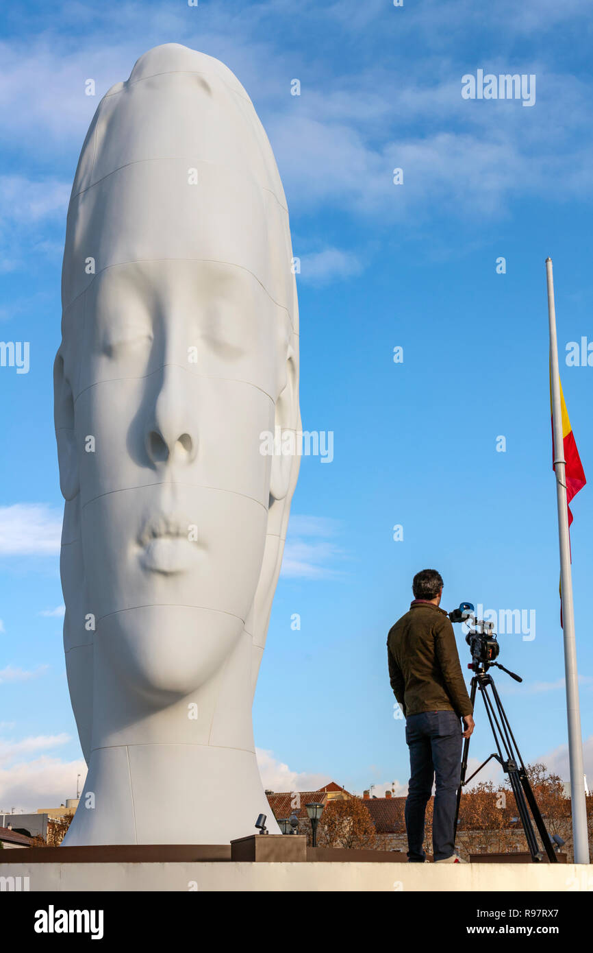 Cameraman with Julia, white marble sculpture by Jaume Plensa in Plaza Colon, Madrid, Spain Stock Photo