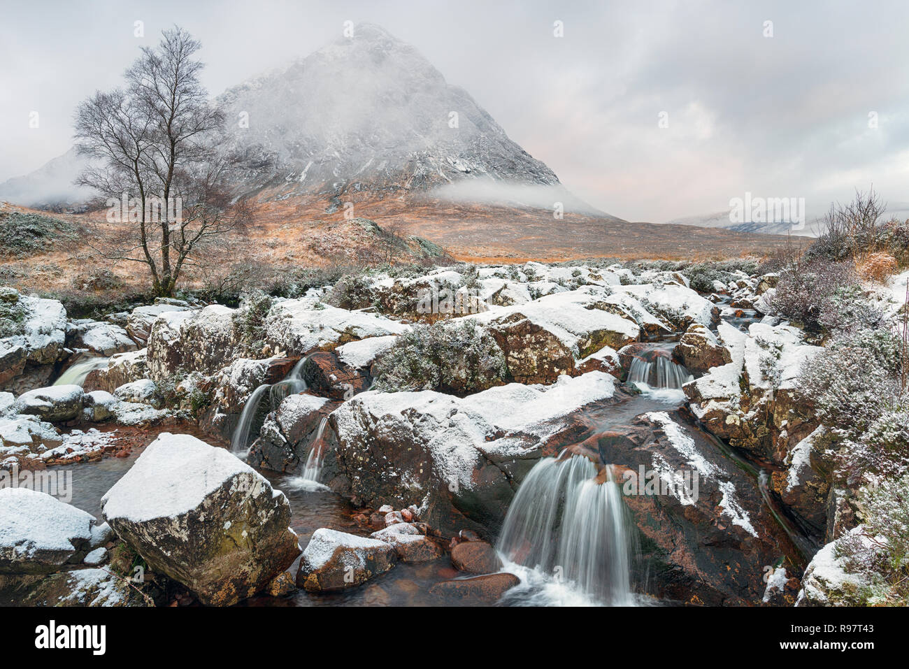 Snow at Buachaille Etive Mor waterfall near Glencoe in the highlands of Scotland Stock Photo