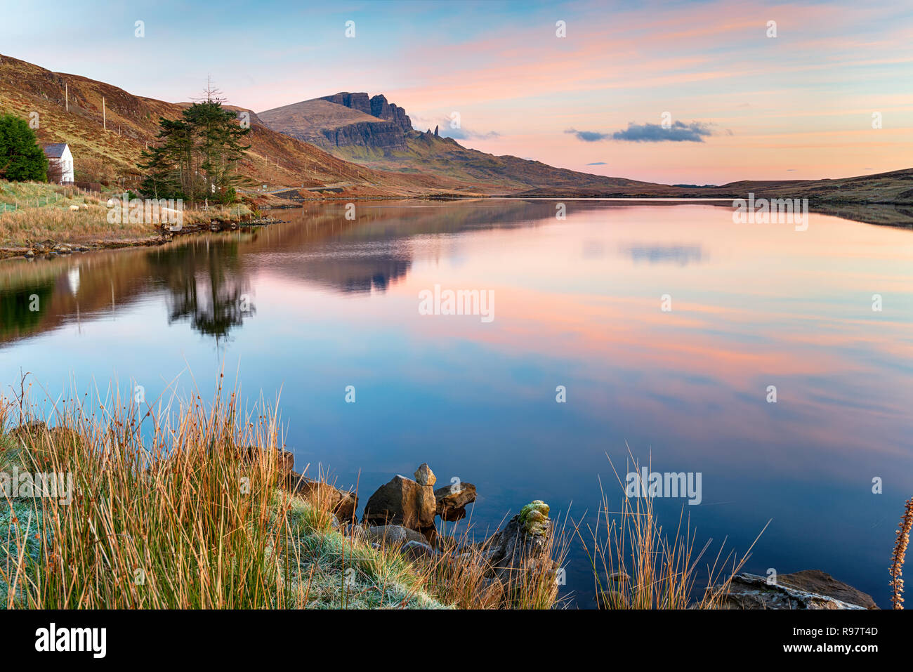 Beautiful sunrise over Loch Fada on the Isle of Skye with the Old Man of Storr in the distance Stock Photo