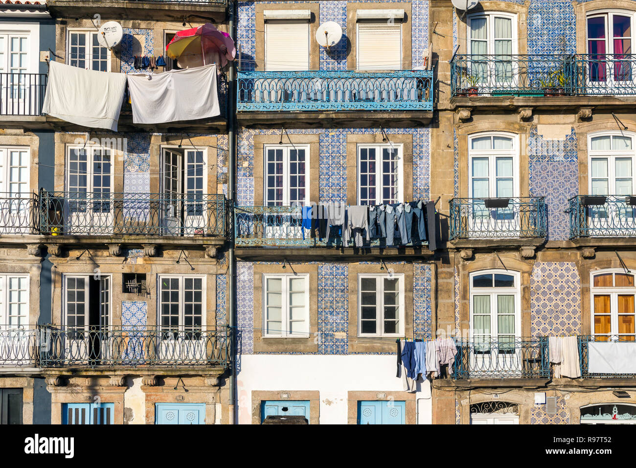 Street view on the beautiful old buildings with portuguese tiles azulejo on the facades in Porto city, Portugal Stock Photo