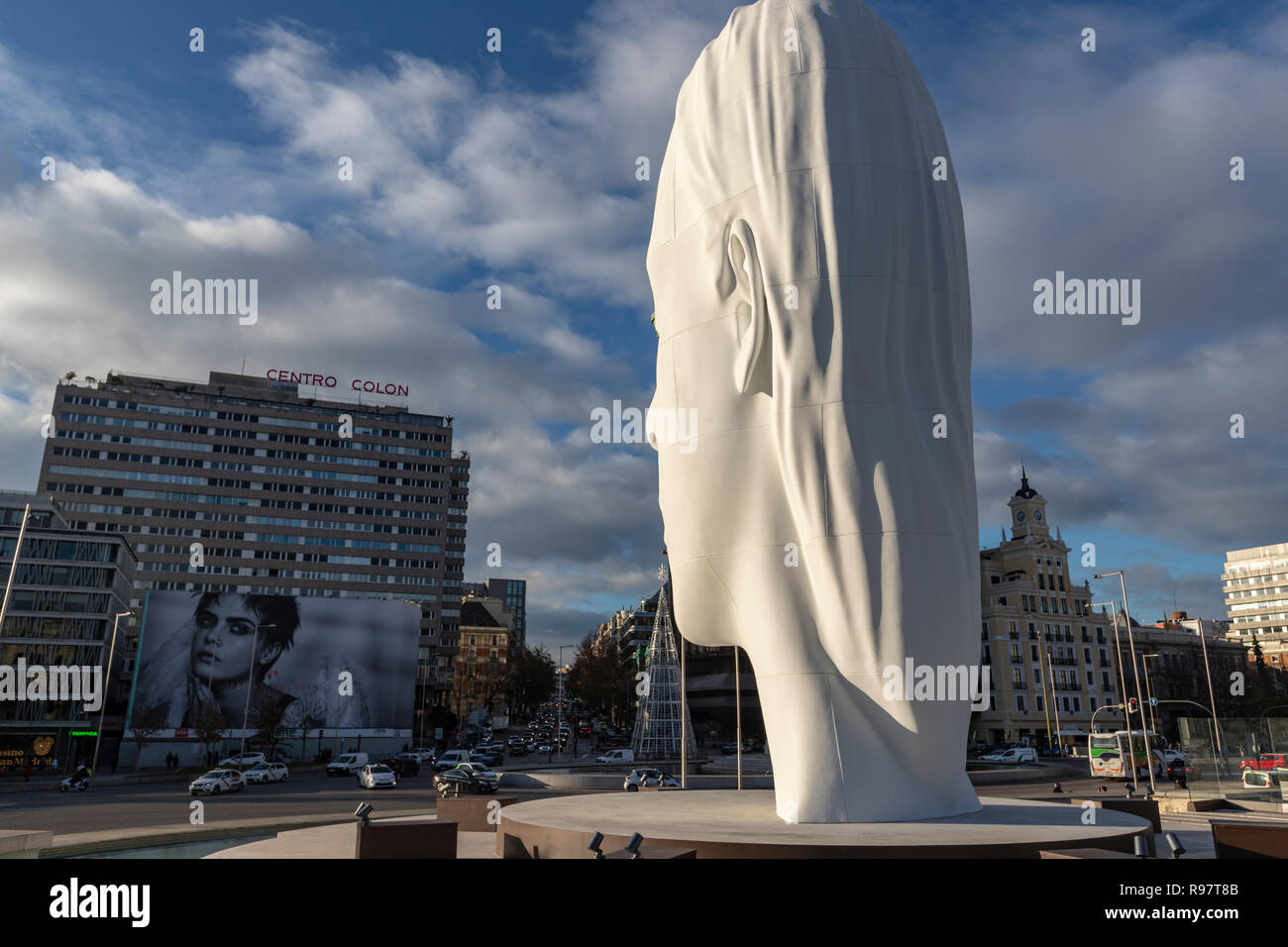 Julia, white marble sculpture by Jaume Plensa in Plaza Colon facing Douglas angel advertisement, Madrid, Spain Stock Photo