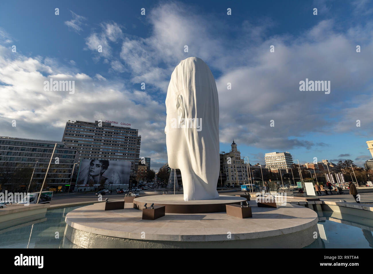 Julia, white marble sculpture by Jaume Plensa in Plaza Colon facing Douglas angel advertisement, Madrid, Spain Stock Photo
