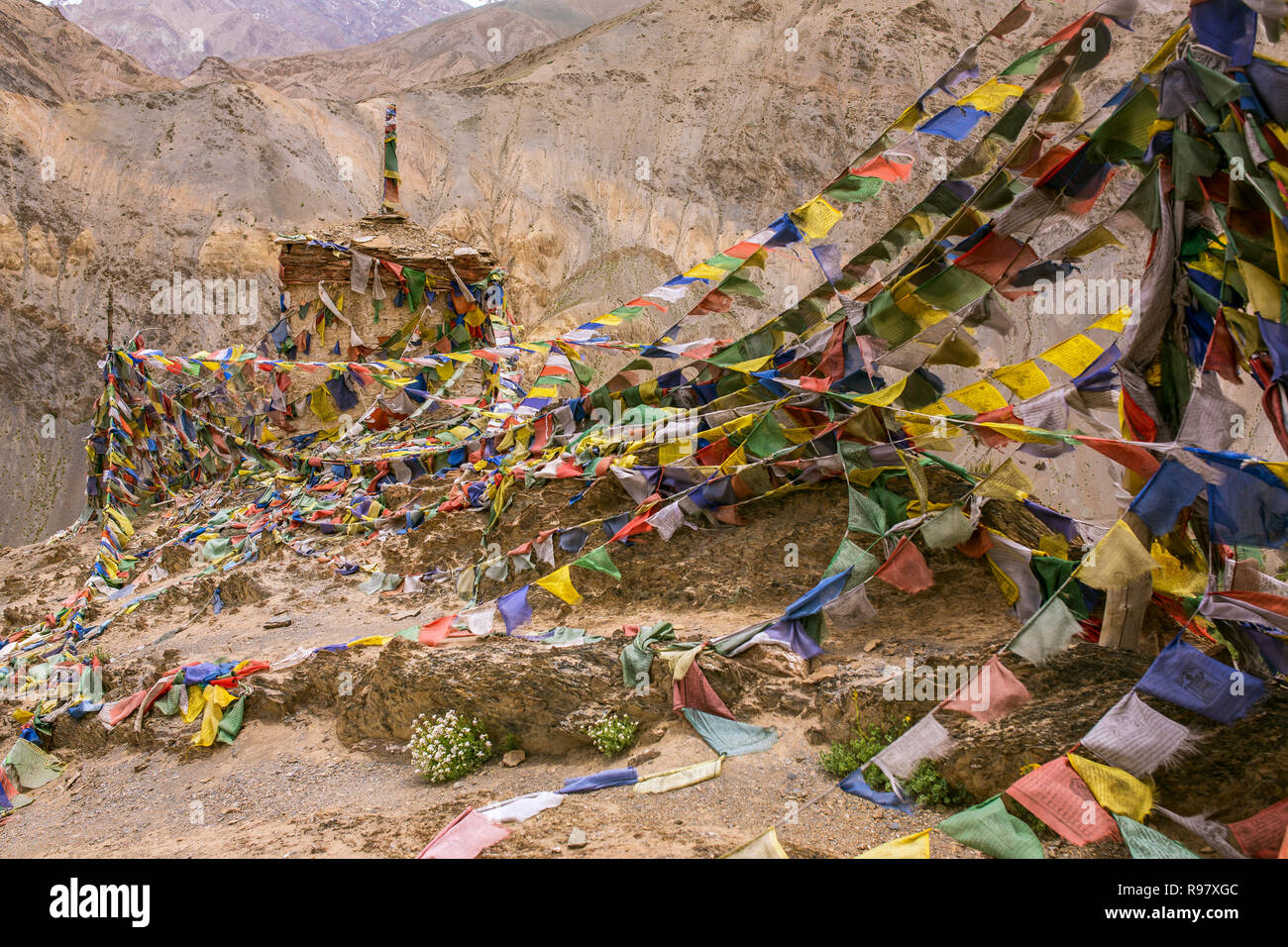 Tibetan buddhist prayer flags and praying wheels in Darjeeling, India. Traditionally, the mantra Om Mani Padme Hum is written in Sanskrit on the outsi Stock Photo