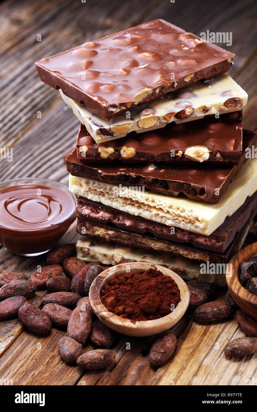 Chocolate bars on table with chocolate tower. Chocolate and nuts Stock Photo