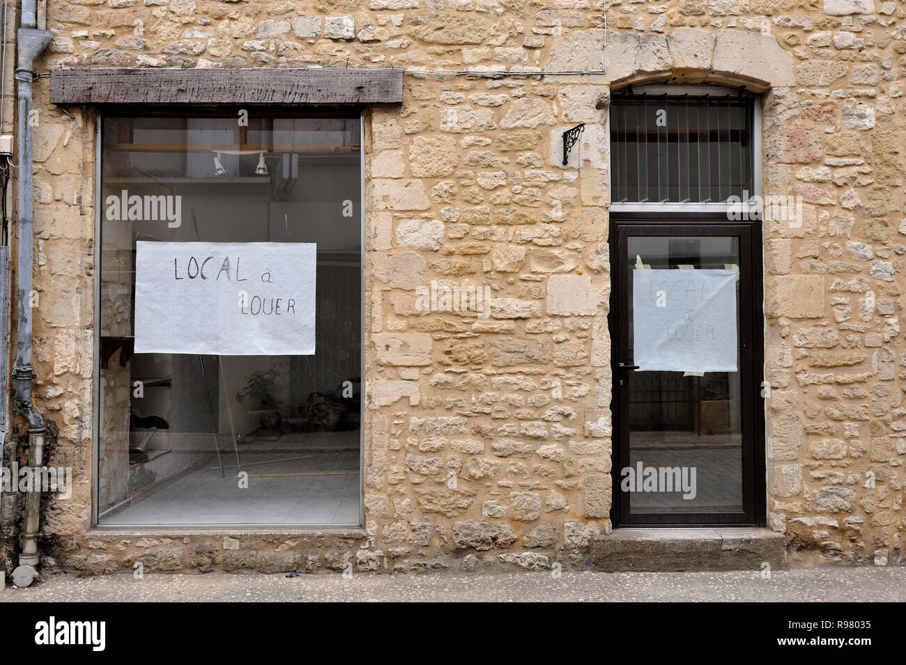 Shop to let in small village in France. (text on window in French 'Local a louer' means shop to let) Stock Photo