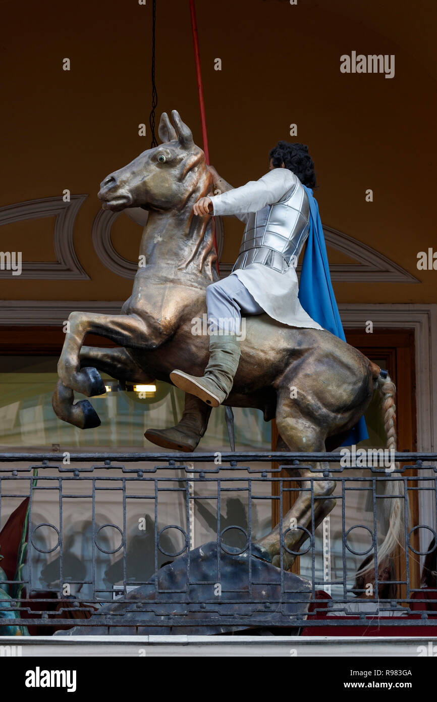 Movie mannequin characteron horseback and costume on display along a