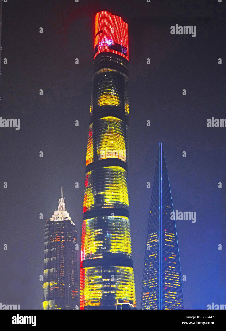 Skyscrapers in Pudong financial district of Shanghai at night include, from left to right: Jinmao Tower, Shanghai Tower, and World Financial Center Stock Photo