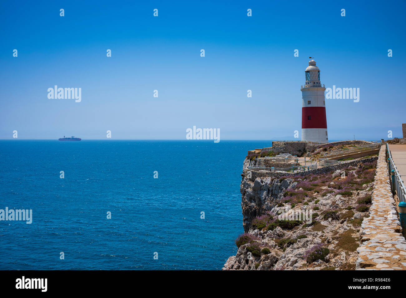 The Trinity House Lighthouse, built in 1841, is located at Gibraltar's southernmost point offers dramatic ocean views on a cloudless summer day. Stock Photo