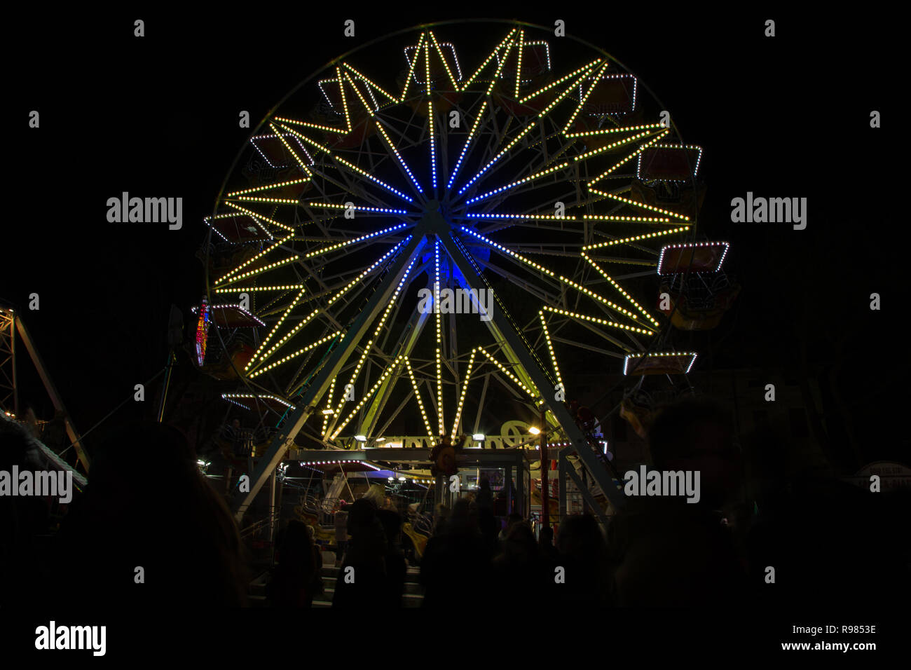 Gorizia, Italy - December 02, 2018: Annual traditional Christmas fair in center of Gorizia city, Italy. Ferris wheel on the background. Stock Photo