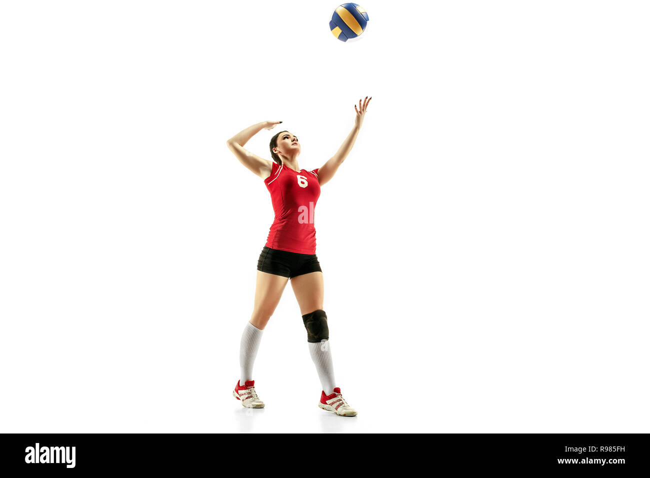 Female professional volleyball player isolated on white with ball. The