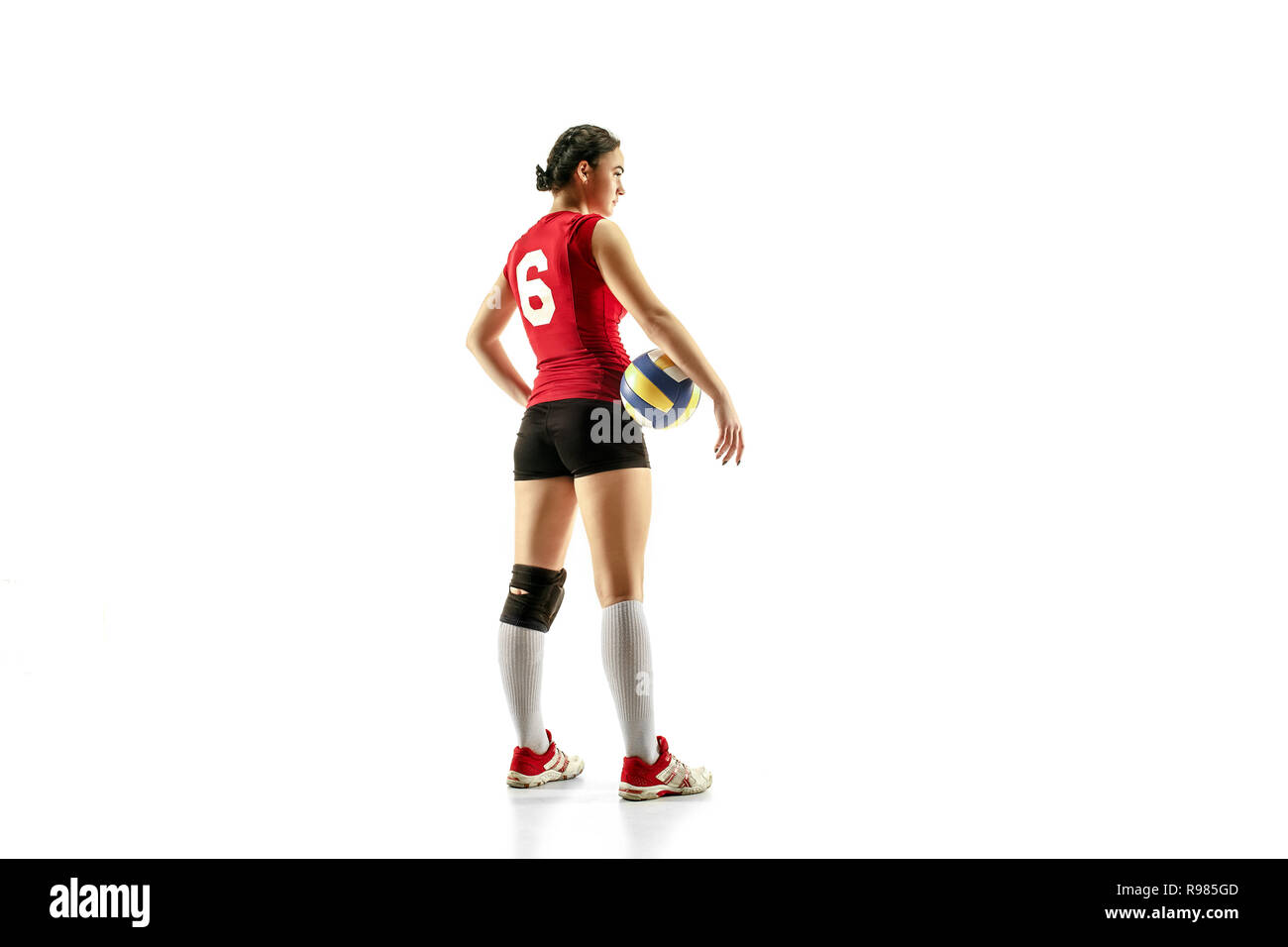 Female professional volleyball player isolated on white with ball. The