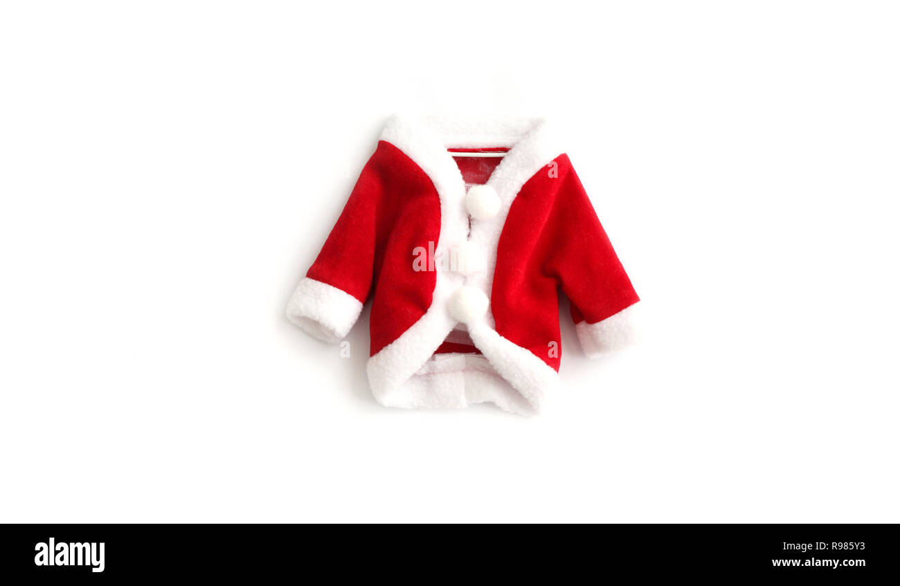 Christmas background Santa Claus (Saint Nicholas) red mini coat suit costume white cuffs flat lay isolated middle white background. Concept photo for  Stock Photo