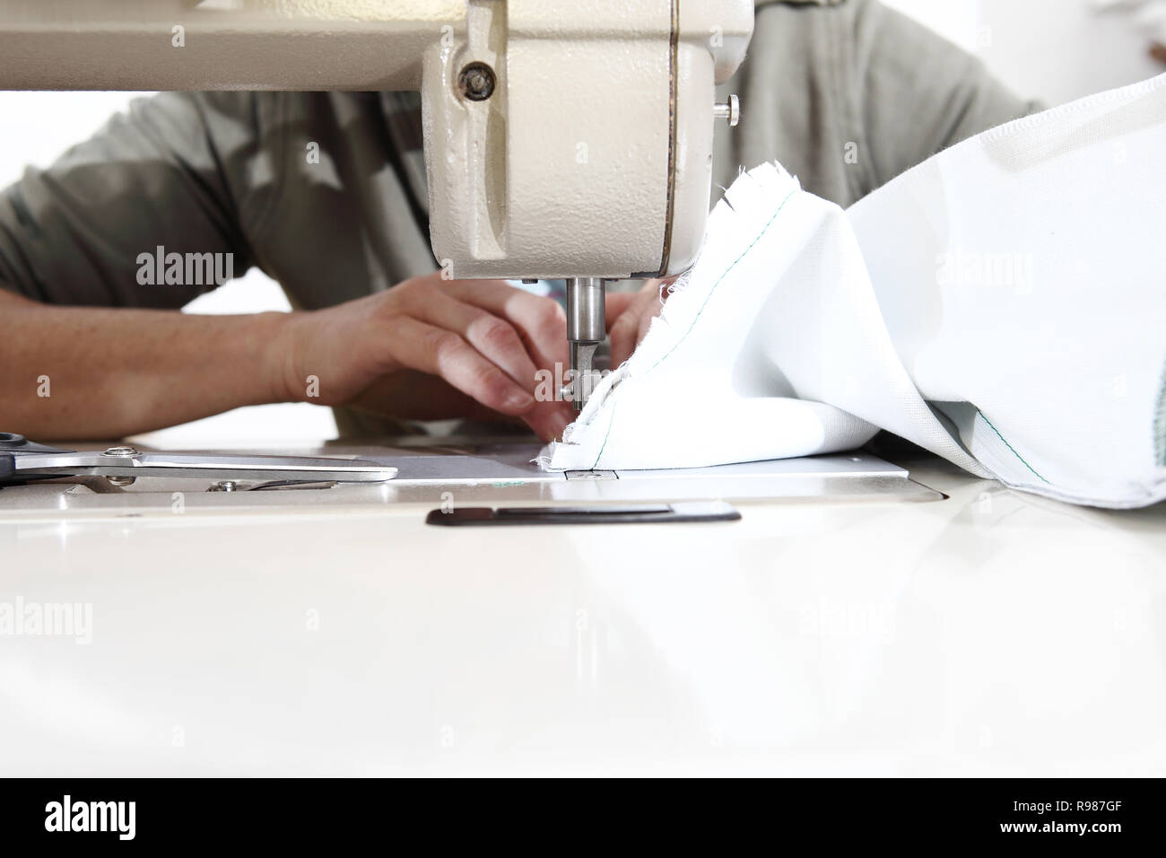 woman hands sewing machine, close up Stock Photo