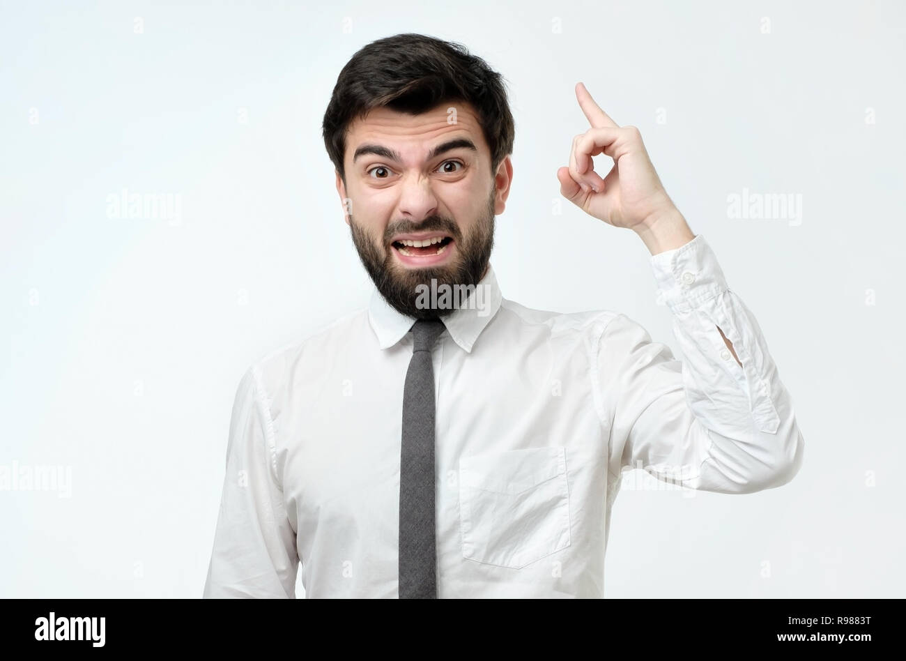 Angry man in ite and white shirt screaming Stock Photo