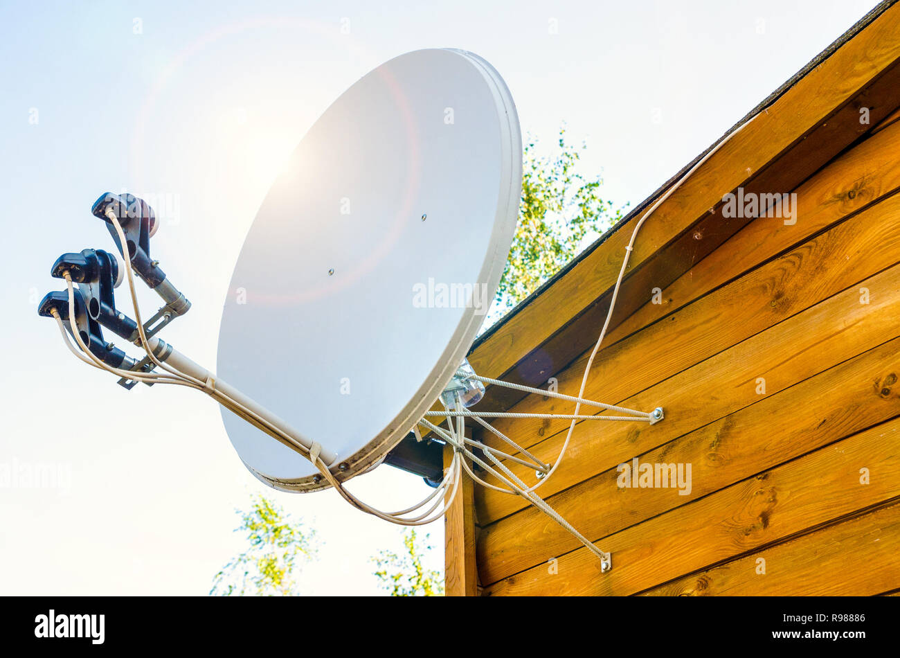 satellite antenna on a wooden house outdoors Stock Photo Alamy