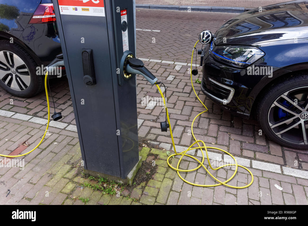 Electric car at charging point in Amsterdam, Netherlands Stock Photo