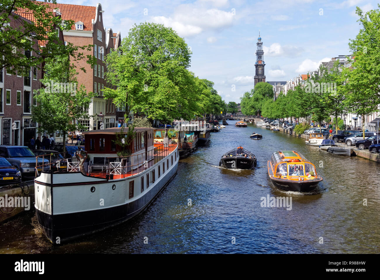 Tourist cruise boats on Prinsengracht canal in Amsterdam, Netherlands Stock Photo