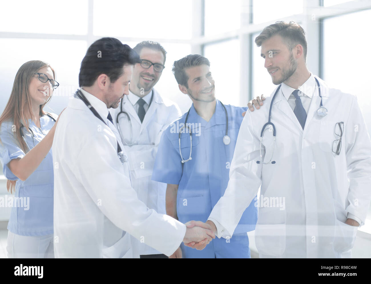 Doctors partners shaking hands hi-res stock photography and images - Alamy